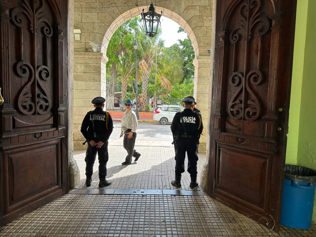 Twee ploitieagenten aan de poort van het gouverneurshuis. 