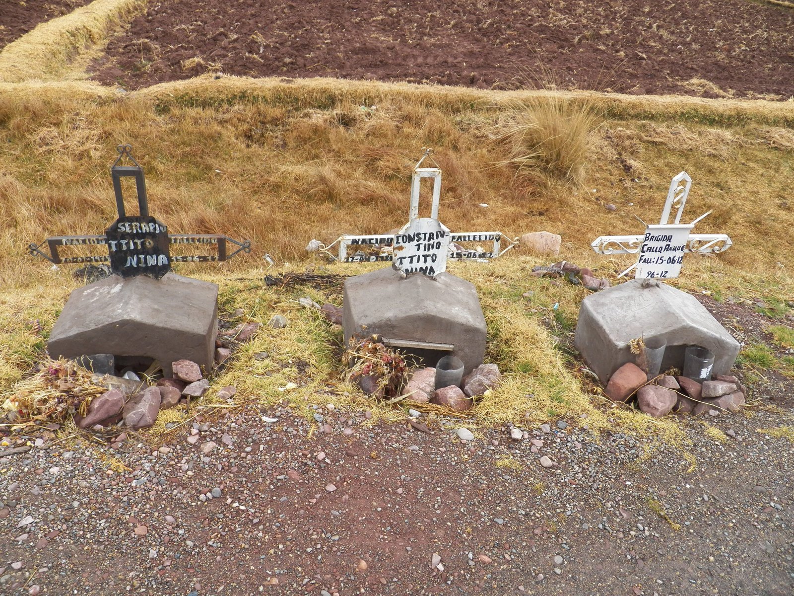 Drie kleine graven langs de rand van de weg.