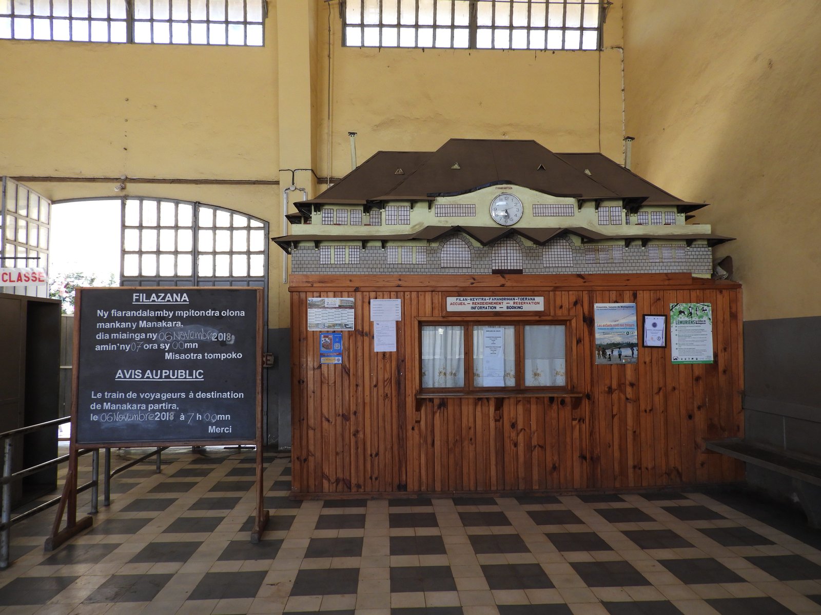 Binnenkant treinstation: houten kantoor met bovenop replica van station zelf.