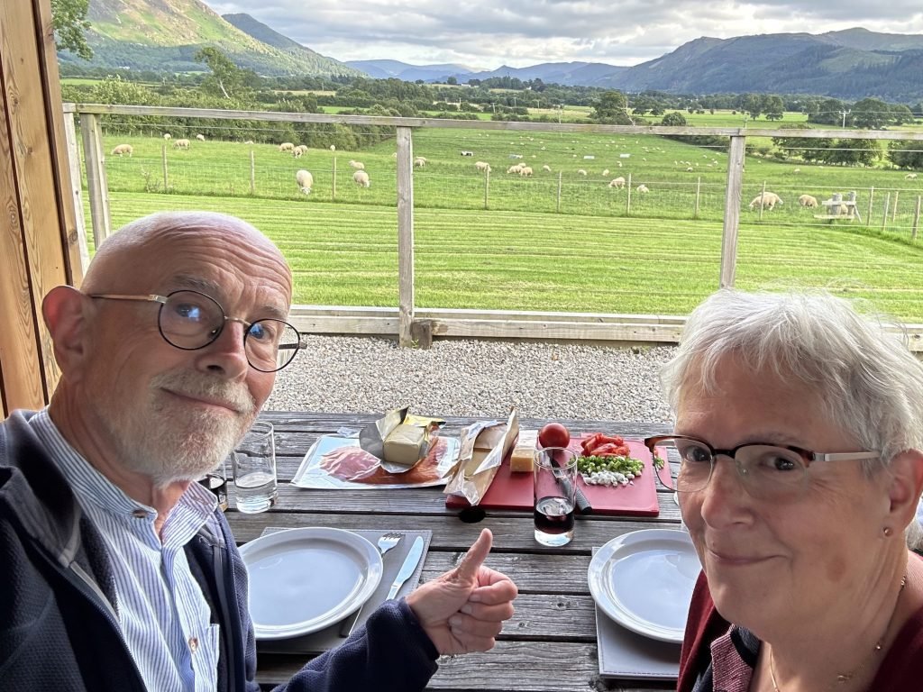 Toeristen eten gerookte zalm voor zonnig berglandschap. 